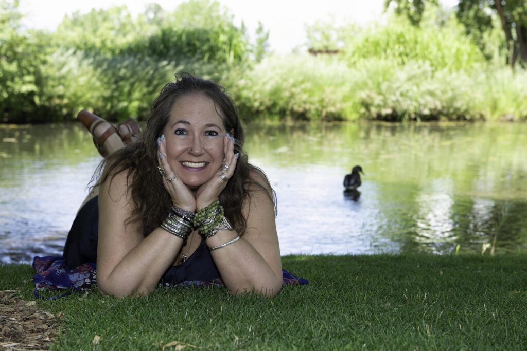 Jessica laying in the grass smiling